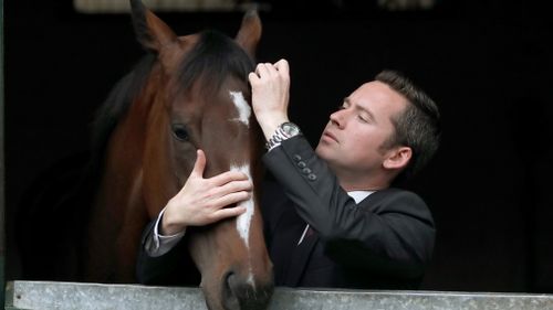 Horse trainer Adrian Bott with "English".