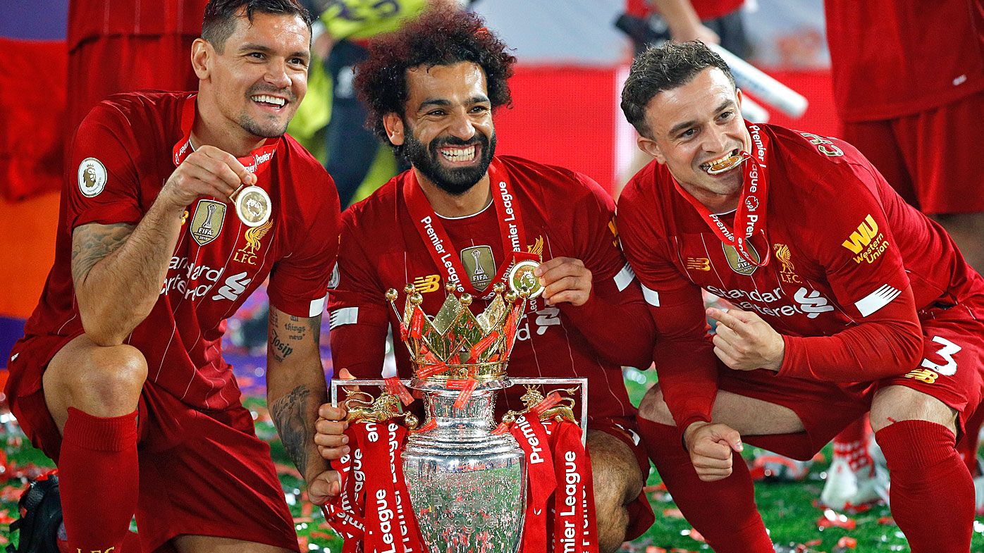Dejan Lovren, Mohamed Salah and Xherdan Shaqiri of Liverpool celebrate with The Premier League trophy 
