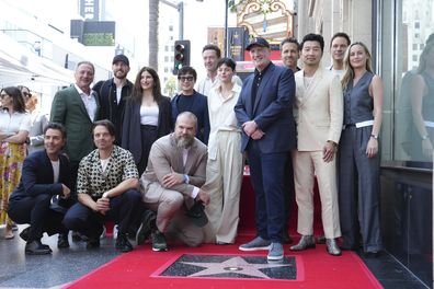 Shawn Levy, from left, Louis D'Esposito, Sebastian Stan, Chris Evans, Kathryn Hahn, David Harbour, Ke Huy Quan, Hugh Jackman, Emma Corrin, Kevin Feige, Ryan Reynolds, Simu Liu, Chris Pratt and Brie Larson attend a ceremony honoring Feige with a star on the Hollywood Walk of Walk of Fame