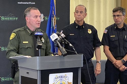 Washoe County Sheriff Darin Balaam, left, answers a reporter's question as fire officials look on during a news conference in Reno, Nev., on Tuesday, Jan. 3, 2023, about the accident that seriously injured actor Jeremy Renner on a private mountain road near Lake Tahoe on New Year's Day. 