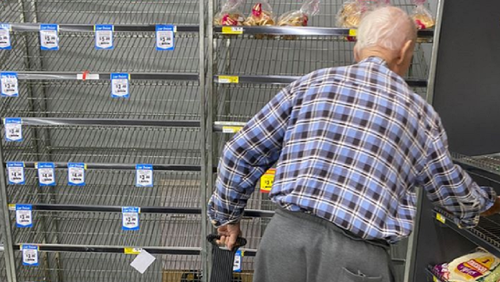 Man at IGA in Australia looking for bread.