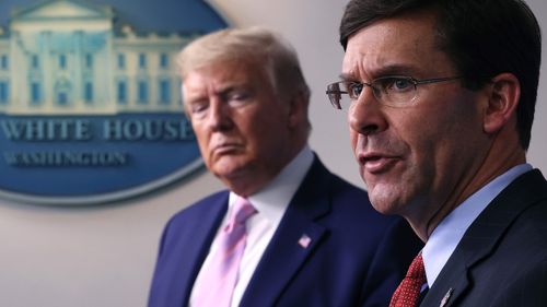 Secretary of Defence Mark Esper speaks as US President Donald Trump listens during a daily White House coronavirus press briefing, in April