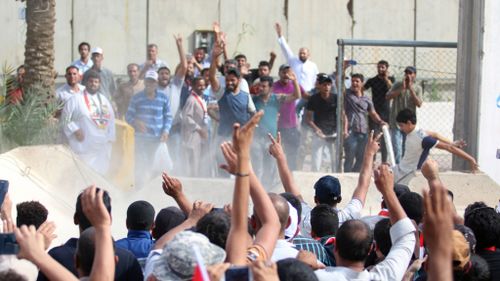 Iraqi protesters breached a concrete wall to enter the Green Zone. (AFP)