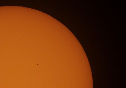 Mercury, centre left, passes between Earth and the sun.