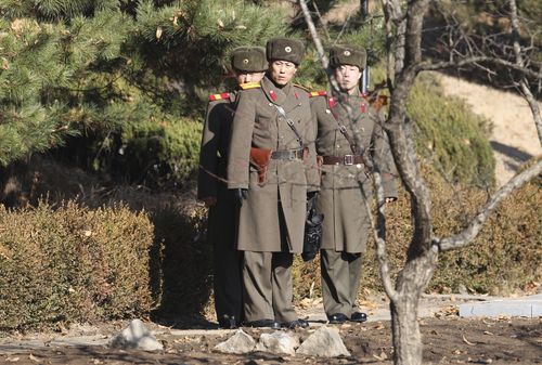 North Korean soldiers look at the South side at the spot where a North Korean soldier crossed the border. (AAP)