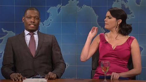 Cecily Strong playing 'Girl you wish you hadn't started a conversation with at a party' on Saturday Night Live, alongside Weekend Update anchor Michael Che.