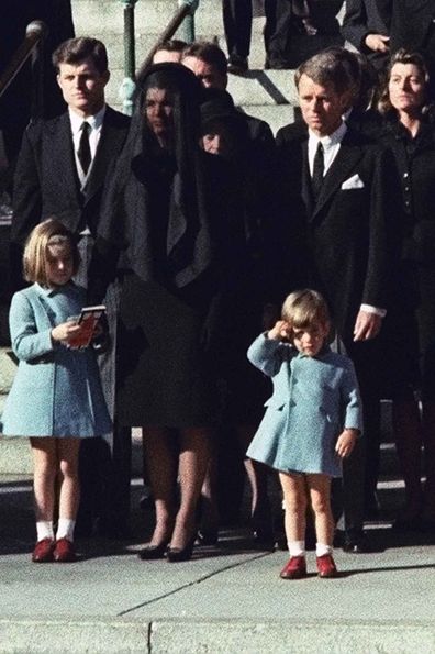 John F Kennedy Jr salutes his father's coffin at his funeral in 1963, alongside his uncles Ted (left) and Robert (right), and mother Jackie.
