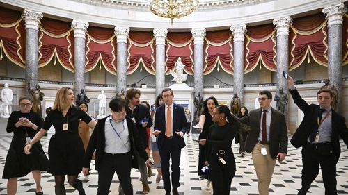 Rep. Dusty Johnson, R-S.D., talks with reporters after attending a meeting with Speaker of the House Mike Johnson, R-La., as the House works on a spending bill to avert a shutdown of the Federal Government, Friday, Dec. 20, 2024, at the Capitol in Washington. (AP Photo/John McDonnell)