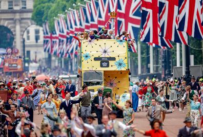 Catherine Jenkins, Chris Eubank, Giles Terera and Cliff Richard ride a bus along the Mall during the Platinum Pageant on June 05, 2022 in London, England, celebrating a vibrant display of British life since 1972 