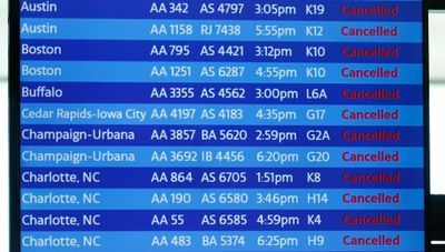 A digital board shows flight cancellations at Terminal 3 at O'Hare International Airport in Chicago, Illinois.
