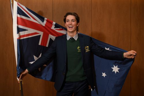 Australian halfpipe snowboarder Scotty James poses for a photograph with the Australian flag after being announced as the team flag bearer. (AAP)