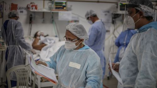 A chief nurse checks patient reports at the Intensive Treatment Unit at the Gilberto Novaes Municipal Field Hospital in Manaus, Brazil.