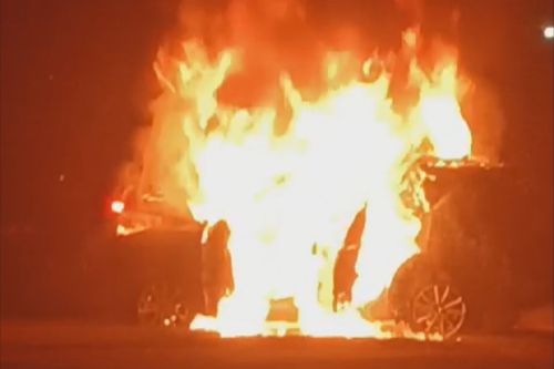 Two men have been arrested after they allegedly took an injured man away from the scene of a firey crash in a shopping trolley and left another 12-year-old boy with injuries in Sydney's west.