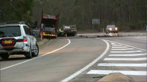 A driver has been killed and another person trapped in the wreckage of a vehicle during a two-truck collision on Picton Road in Wilton, in Sydney's south-west.