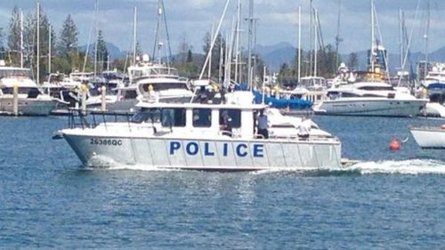 A Water Police boat brings the man's body back to shore. (Alex Bernhardt)