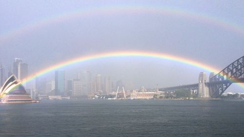 Stunning double rainbow stretches from Sydney Opera House to Harbour Bridge