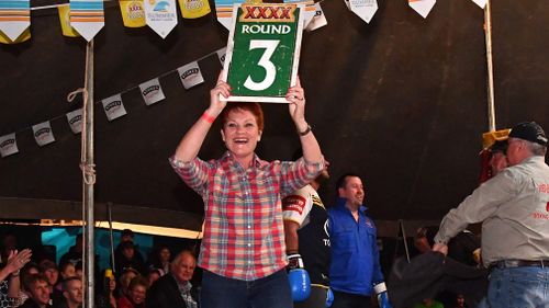 Senator Pauline Hanson acts as the ring girl during the boxing at the Fred Brophy's Boxing Tent in Birdsville. (AAP)