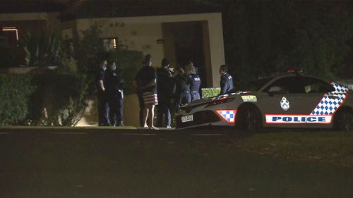 Queensland Police stand outside Toutai Kefu's Brisbane home, where he and his family were attacked.