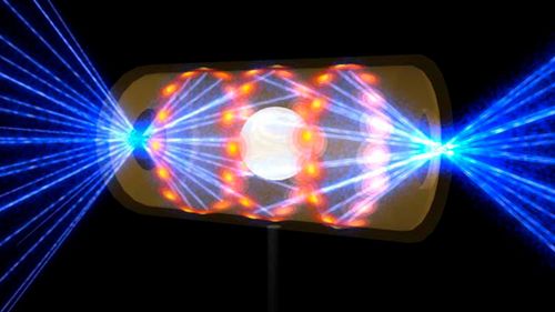 Cette illustration fournie par le National Ignition Facility du Lawrence Livermore National Laboratory représente une pastille cible à l'intérieur d'une capsule de hohlraum avec des faisceaux laser entrant par des ouvertures à chaque extrémité.  Les faisceaux compriment et chauffent la cible jusqu'aux conditions nécessaires pour que la fusion nucléaire se produise.