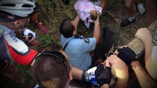 A baby boy abandoned in a drain by his mother is lifted to safety. His mother has been charged with attempted murder. (9NEWS)