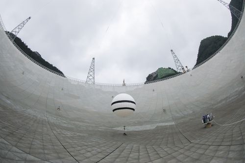 A staff member conducts maintenance of the reflector panels on the Five-hundred-meter Aperture Spherical radio Telescope (FAST)