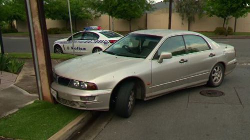 Woman arrested after crashing stolen car into power pole in Adelaide