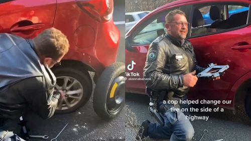 Cop helps change flat tyre