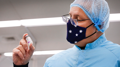 Prime Minister Scott Morrison hold a vial of AsteZeneca produced by the CSL lab in Parkville Melbourne. Picture: David Caird