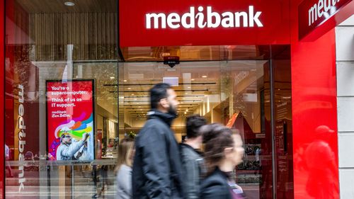 People walk past a Medibank outlet in Sydney.