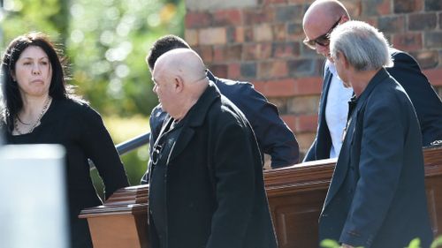 Ex-wife of the late Carl Williams, Roberta Williams (left) carries the casket as a pall bearer at the funeral for George Williams. (AAP)