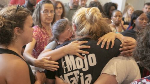 Students who were bussed to First Baptist Church are reunited with family members. (AP)