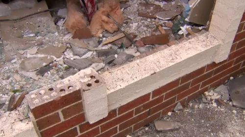 The impact of the crash caused the home's brick walls to crumble. (9NEWS)
