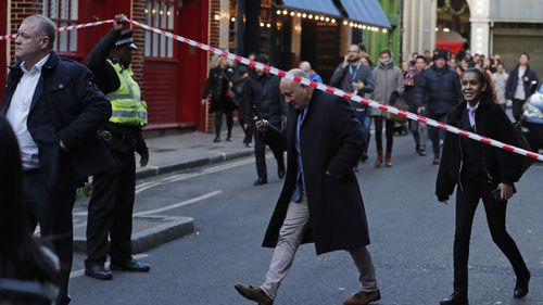 Police evacuate people from Borough Market on the south side of London Bridge in London, Friday, Nov. 29, 2019