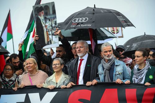 SYDNEY, AUSTRALIA - AUGUST 03: People, including Wikileaks founder Julian Assange and Craig Foster, march towards the Harbour Bridge during a pro-Palestinian rally on August 03, 2025 in Sydney, Australia. Protesters in Sydney and Melbourne joined marches and actions globally, as pressure mounts on the Israeli government over a devastating humanitarian crisis unfolding as its war against Hamas continues. (Photo by Lisa Maree Williams/Getty Images)