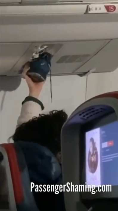 Man hold wet shoe up to plane fan nozzle