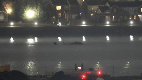 The wreckage of a Black Hawk helicopter is pictured in the Potomac River from Ronald Reagan Washington National Airport, Friday, Jan. 31, 2025, in Arlington, Va. (AP Photo/Alex Brandon)