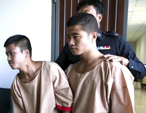 Myanmar migrants Win Zaw Htun, right, and Zaw Lin, left, both 22, are escorted by officials after their guilty verdict at court in Koh Samui, Thailand, in 2015.