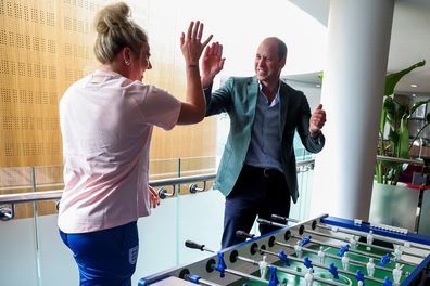 Prince William, Prince of Wales and President of The Football Association, gestures as he plays table football with England's football players, during a visit to England Women's team to wish them luck ahead of the 2023 FIFA Women's World Cup at St Georges Park on June 20, 2023 in Burton-upon-Trent, England 
