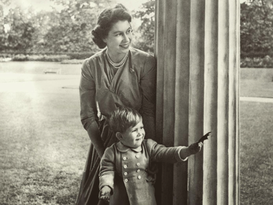 A young Prince Charles plays in the Clarence House garden with his mother, Princess Elizabeth, in 1950. 