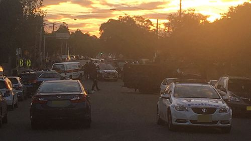Armed police at a property in Punchbowl in Sydney's south-west. (Tiffiny Genders/Twitter)