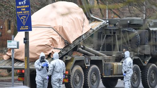 A car is removed from a car park, as the attack is investigated