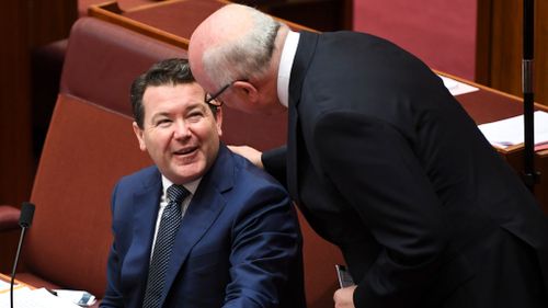 Senator George Brandis (right) and Senator Dean Smith (left) in the senate chamber this morning (AAP)