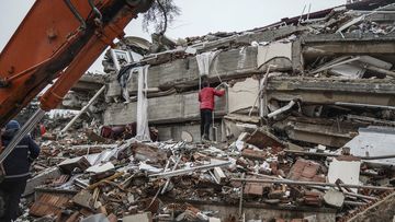 A man searches for people  in the rubble of a destroyed building in Gaziantep, Turkey on Monday.
