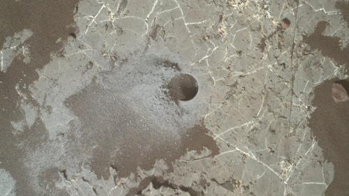 The image shows a drill hole made by Curiosity on Mars' Vera Rubin Ridge.