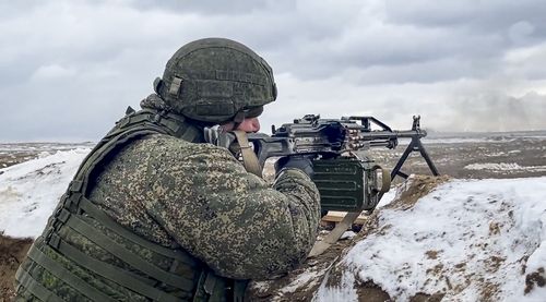 In this photo taken from video and released by the Russian Defense Ministry Press Service on Wednesday, Feb. 2, 2022, a soldier fires during a Russian and Belarusian joint military drills at Brestsky firing range, Belarus.