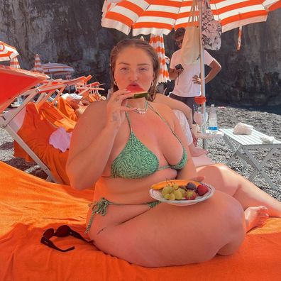 Riley Hemson digs into a fruit platter at a beach club.