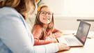 Mother and daughter Having fun with laptop at home