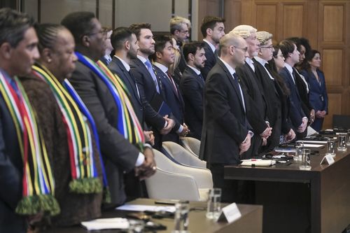 South African, left, and Israel's delegation, right, stand during session at the International Court of Justice, or World Court, in The Hague, Netherlands, Friday, Jan. 26, 2024.  