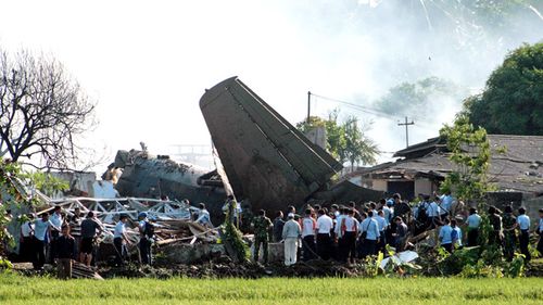Indonesian rescuers search for victims at the plane crash site near Halim Perdana Kusuma airport in Jakarta on  June 2012. An Indonesian Airforce Fokker 27 plane crashed into eight houses in a neighborhood near the Halim Perdanakusuma Airport. No casualties were confirmed.