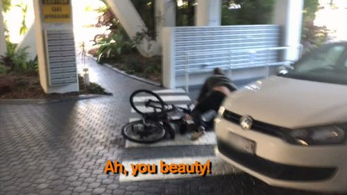 Cycling away, he fell off outside the building.